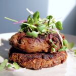 Walnut mushroom burger topped with microgreens