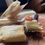 a forkful of tamale with salsa on top